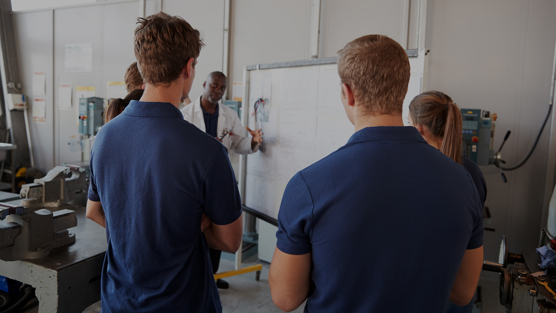 Students in a training environment listening to a trainer.
