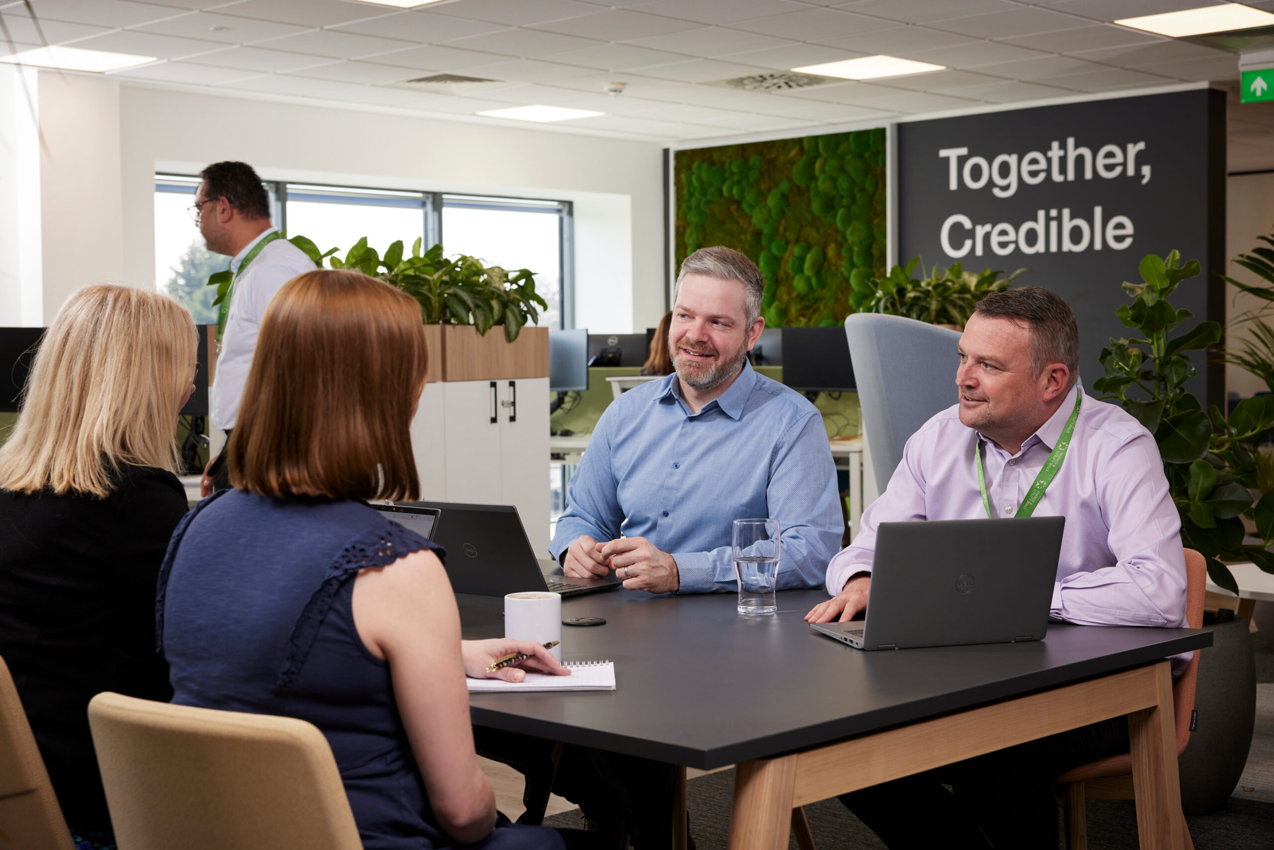 Colleagues at Energy & Utility Skills sitting around a table discussing work.
