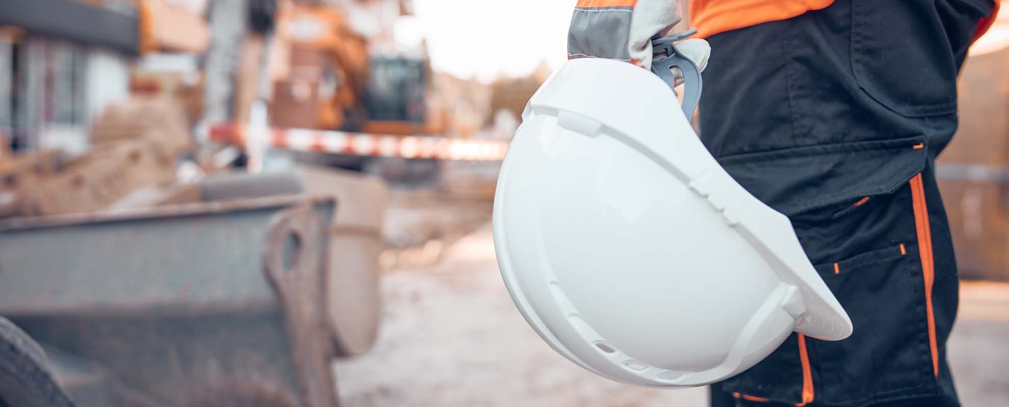 Construction worker holding a hard hat.